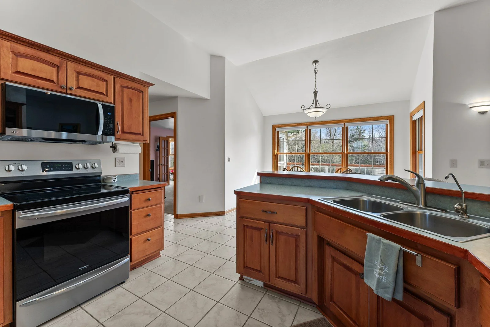 Main level kitchen and informal dining room on other side of peninsula