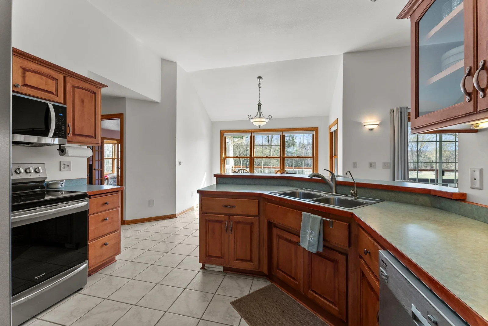 Main level kitchen and informal dining room on other side of peninsula