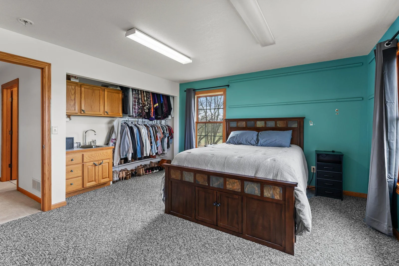Main Level Second Primary Bedroom with sink built into closet!