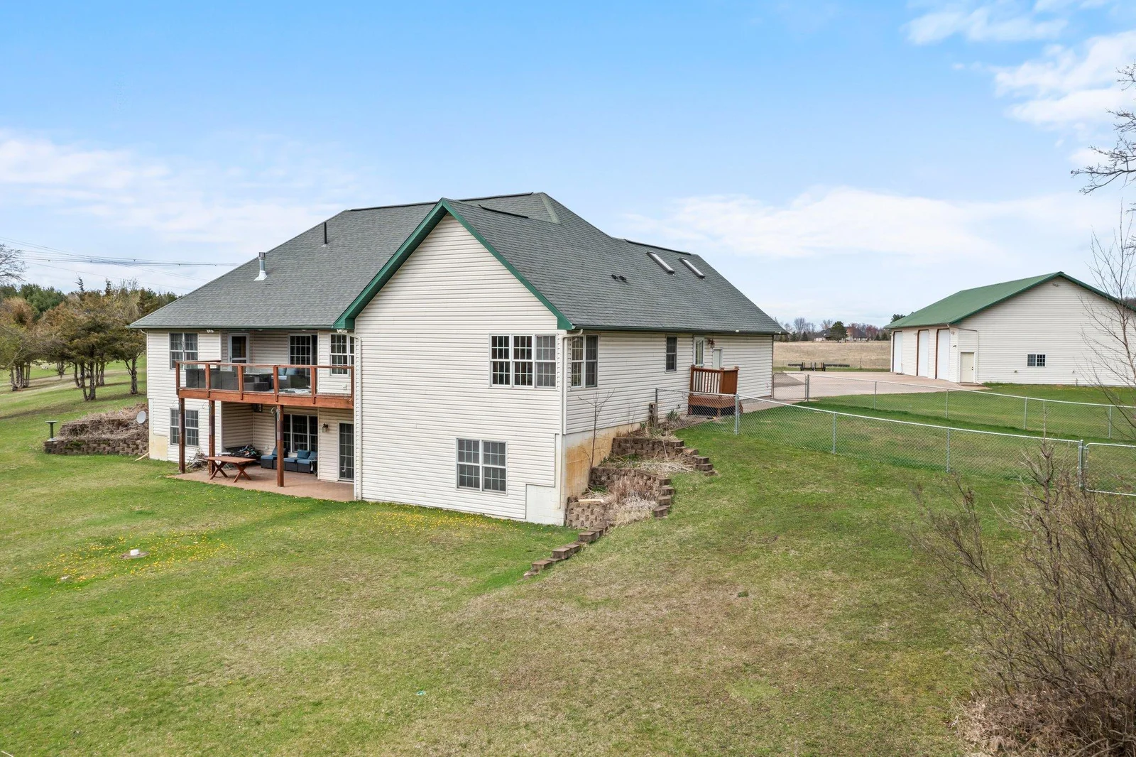 Side/back view of home with fully fenced area for pets