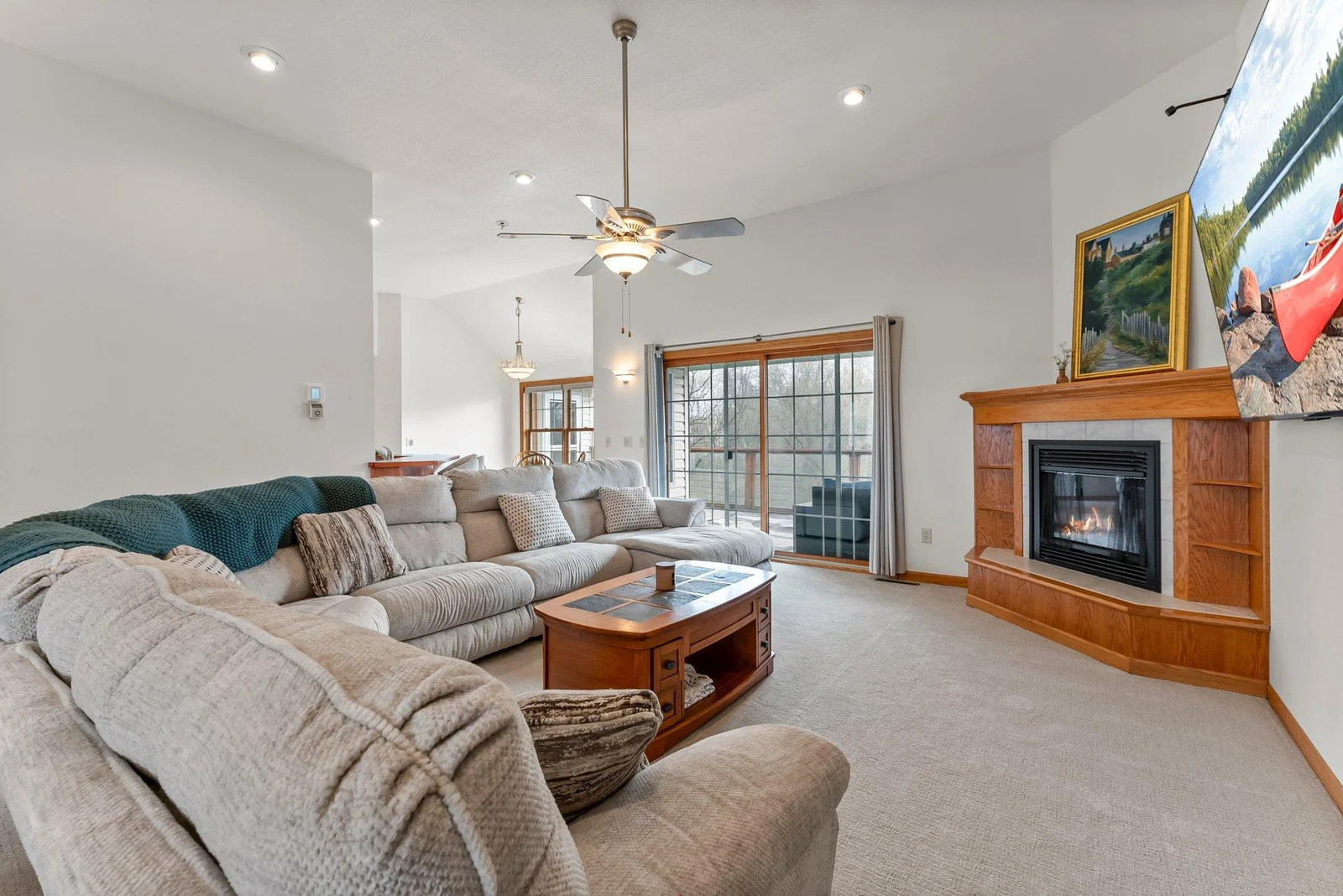Living room with fireplace & patio door that leads to deck
