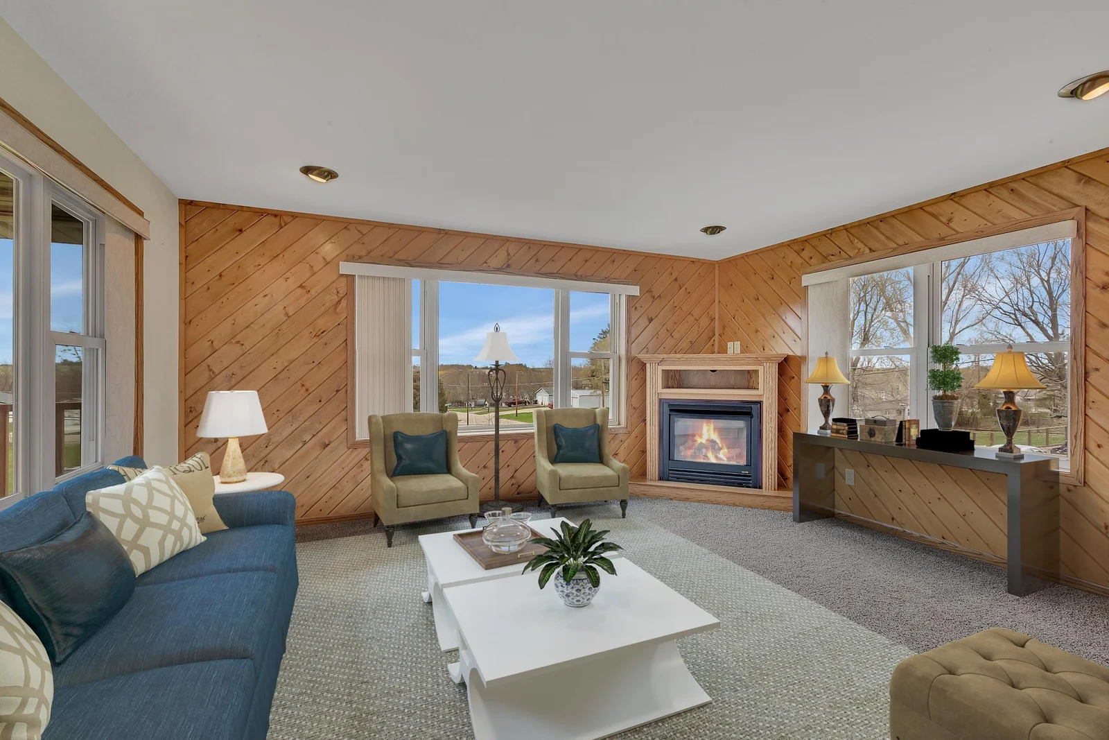 Here is the main level family room which features a gas fireplace, knotty pine walls and new carpet flooring.