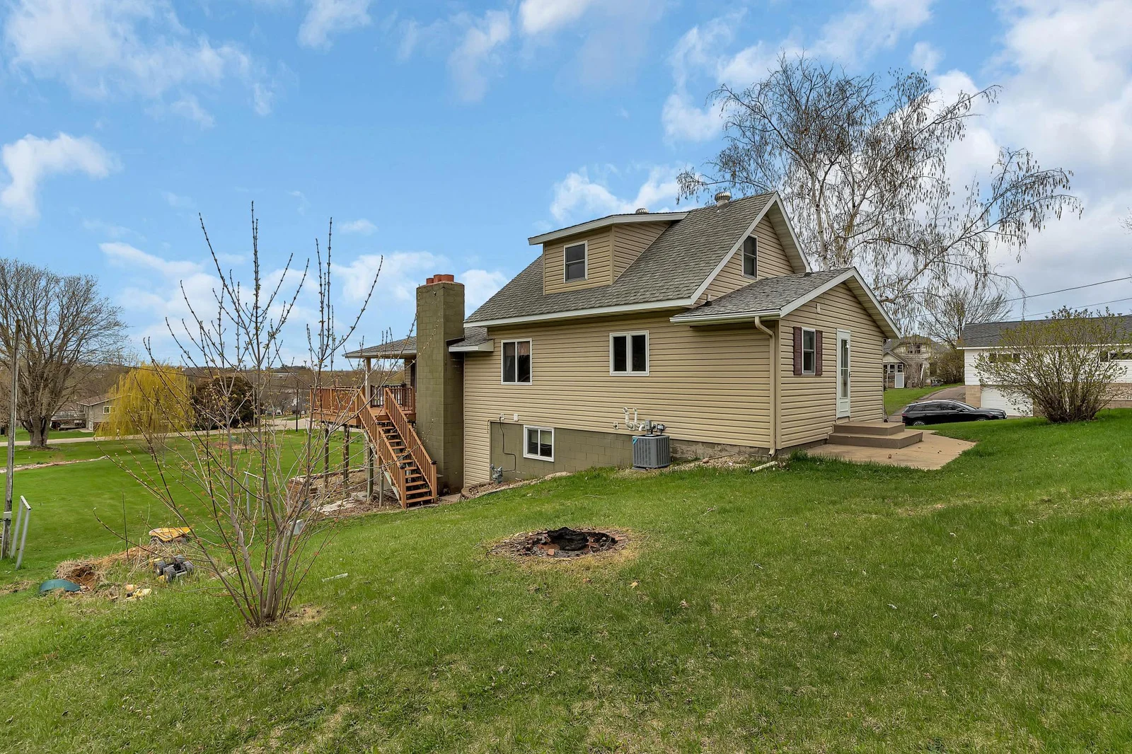 The clean lines of the vinyl siding and architectural shingles set the tone for a well-cared-for property.