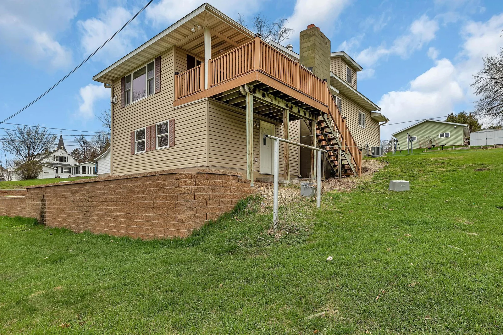 A decorative block retaining wall enhances the yard’s landscape and curb appeal.