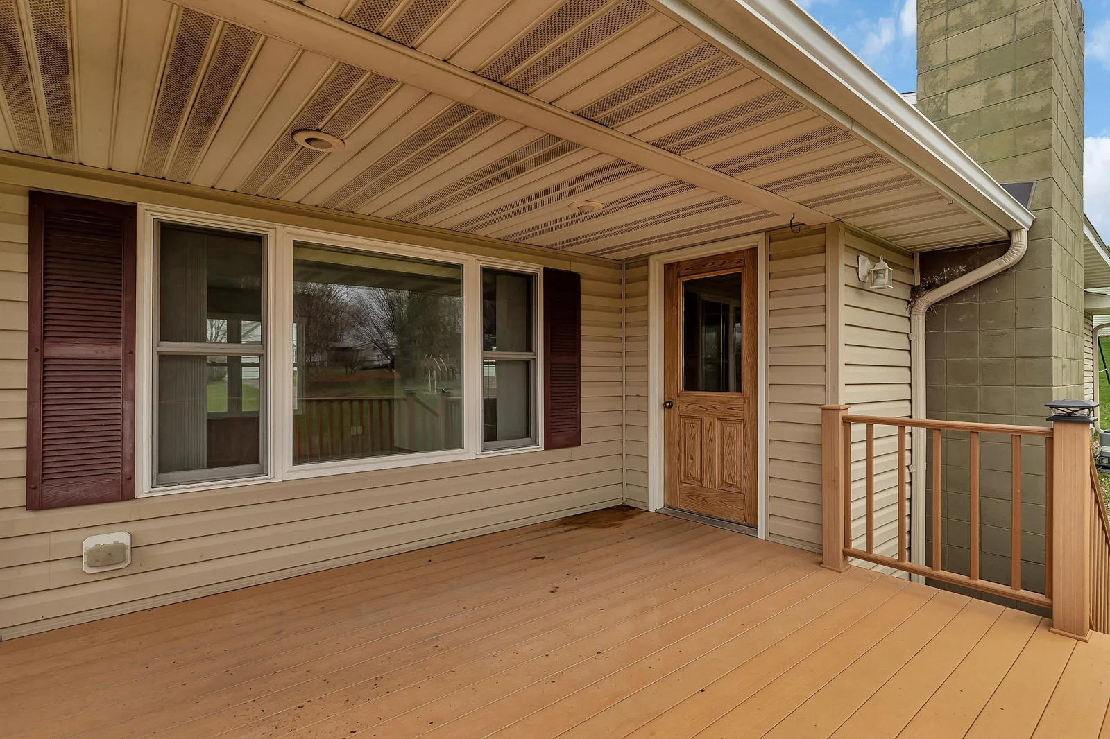 Covered portion of deck with soffit recessed lighting so you can be out grilling even in the rain.