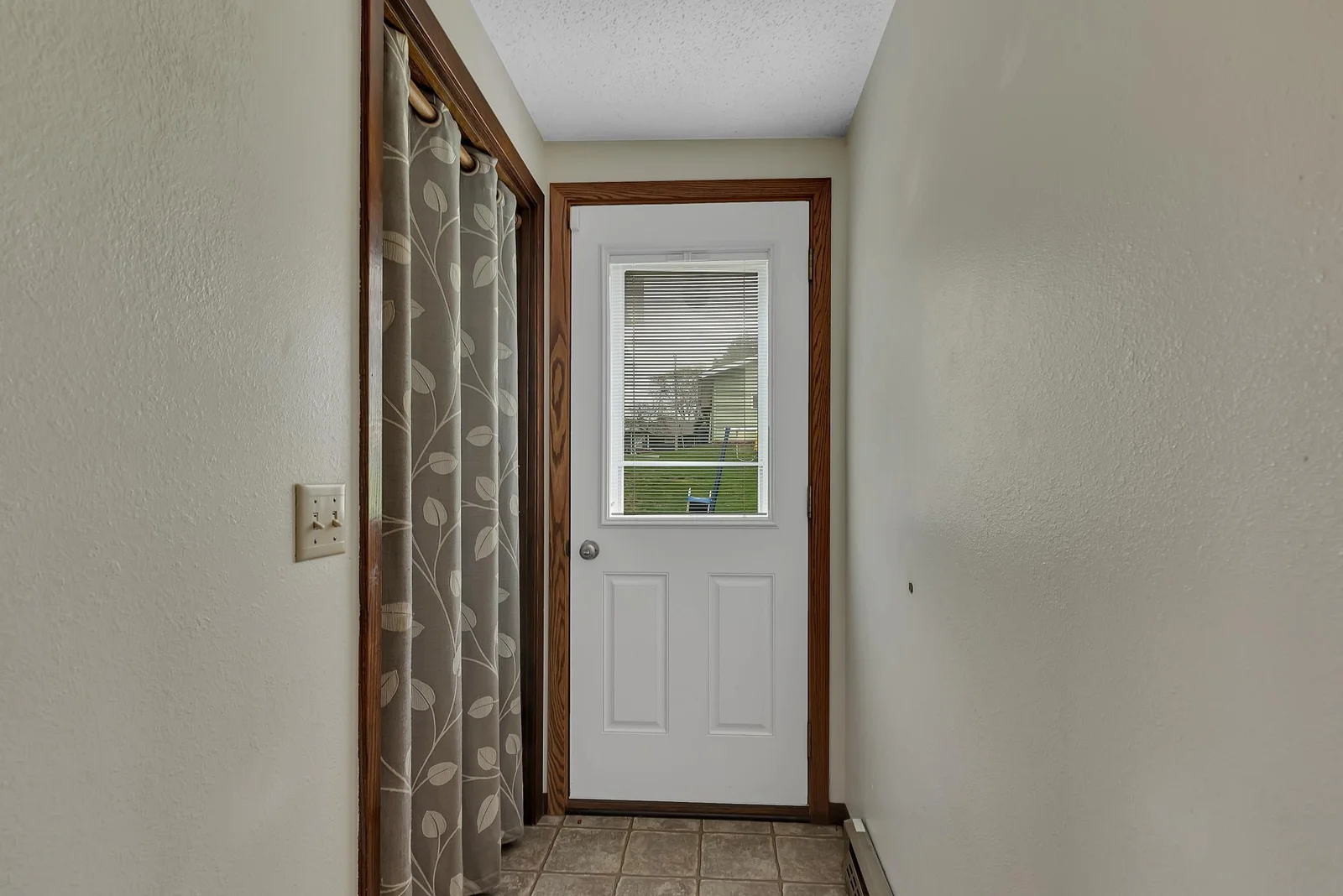 Main level entry door just off the kitchen with closet for outerwear.