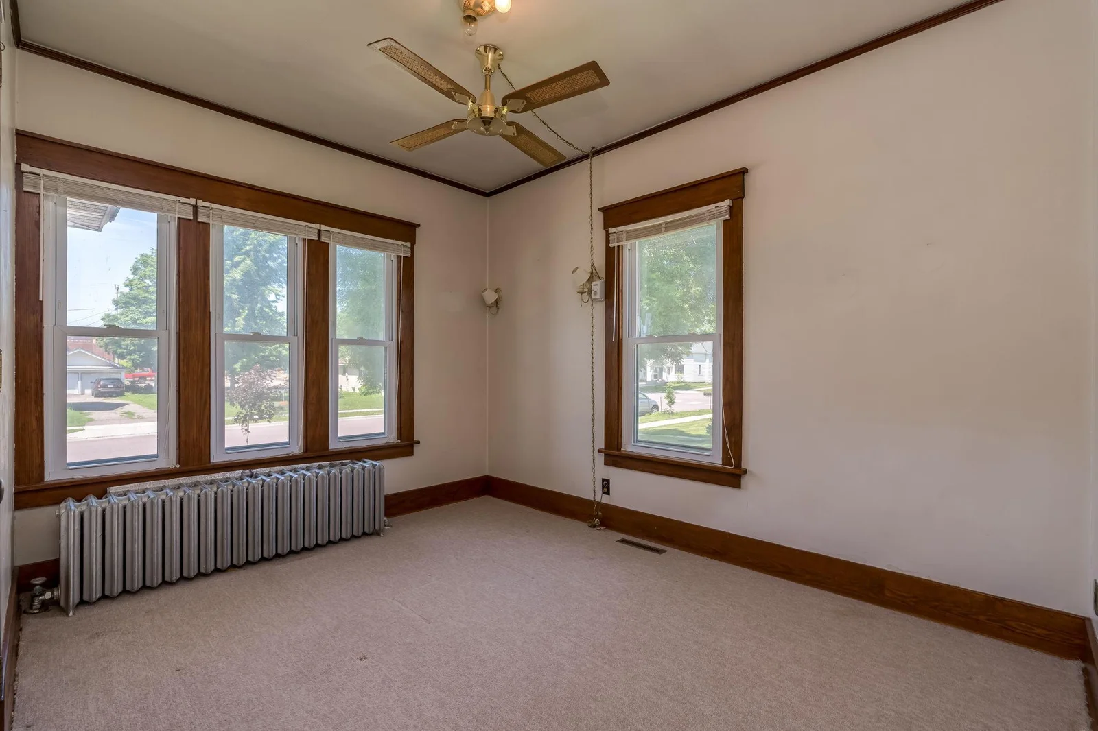 Front bedroom w/ original wood floors preserved below carpet