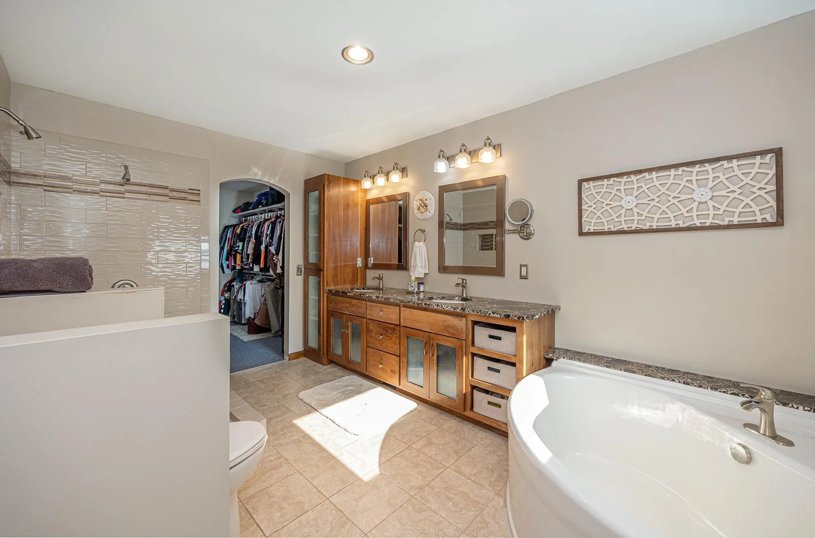 Large primary ensuite with soaker tub and custom tile shower.