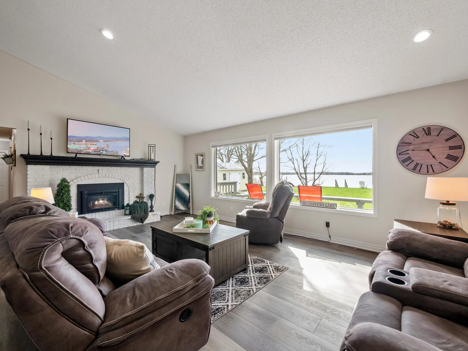 The spacious living area is centered around a cozy fireplace, creating a warm and inviting atmosphere.