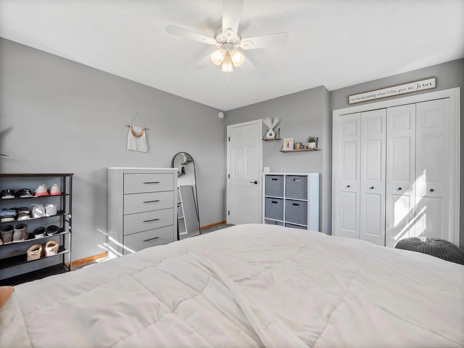 The second main floor bedroom also has neutral colors, plush carpet, and a ceiling fan. Ideally located near the primary bedroom for keeping loved ones close.