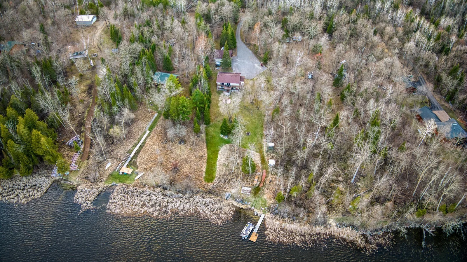 Overview of property. The dock in the water is where the home is located. You can also spot the asphalt driveway
