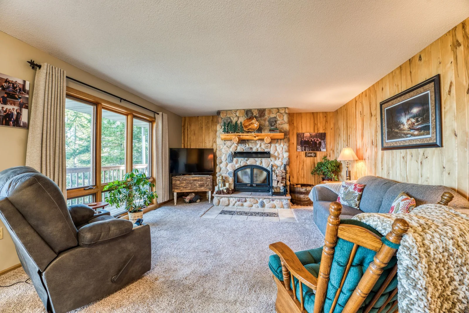 Enjoy the field stone fireplace and large windows in the living room.