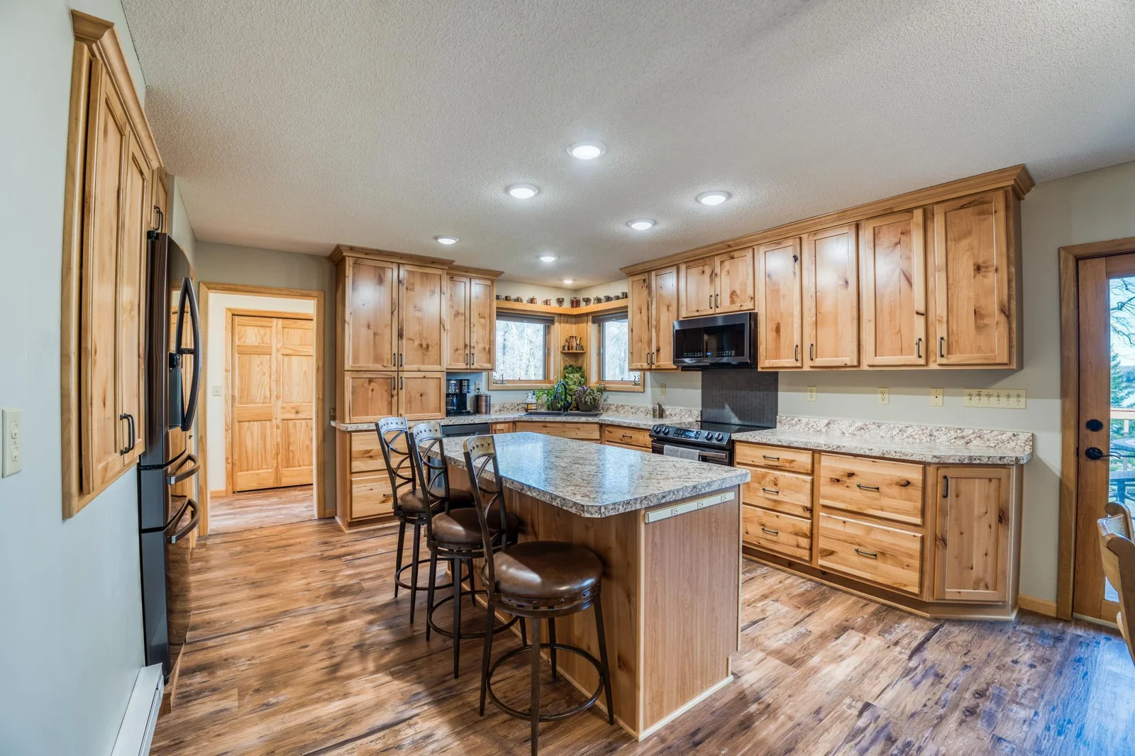 The hickory custom cabinetry provides a nice warm touch. The center Island is a great spot for meal prep and playing cards