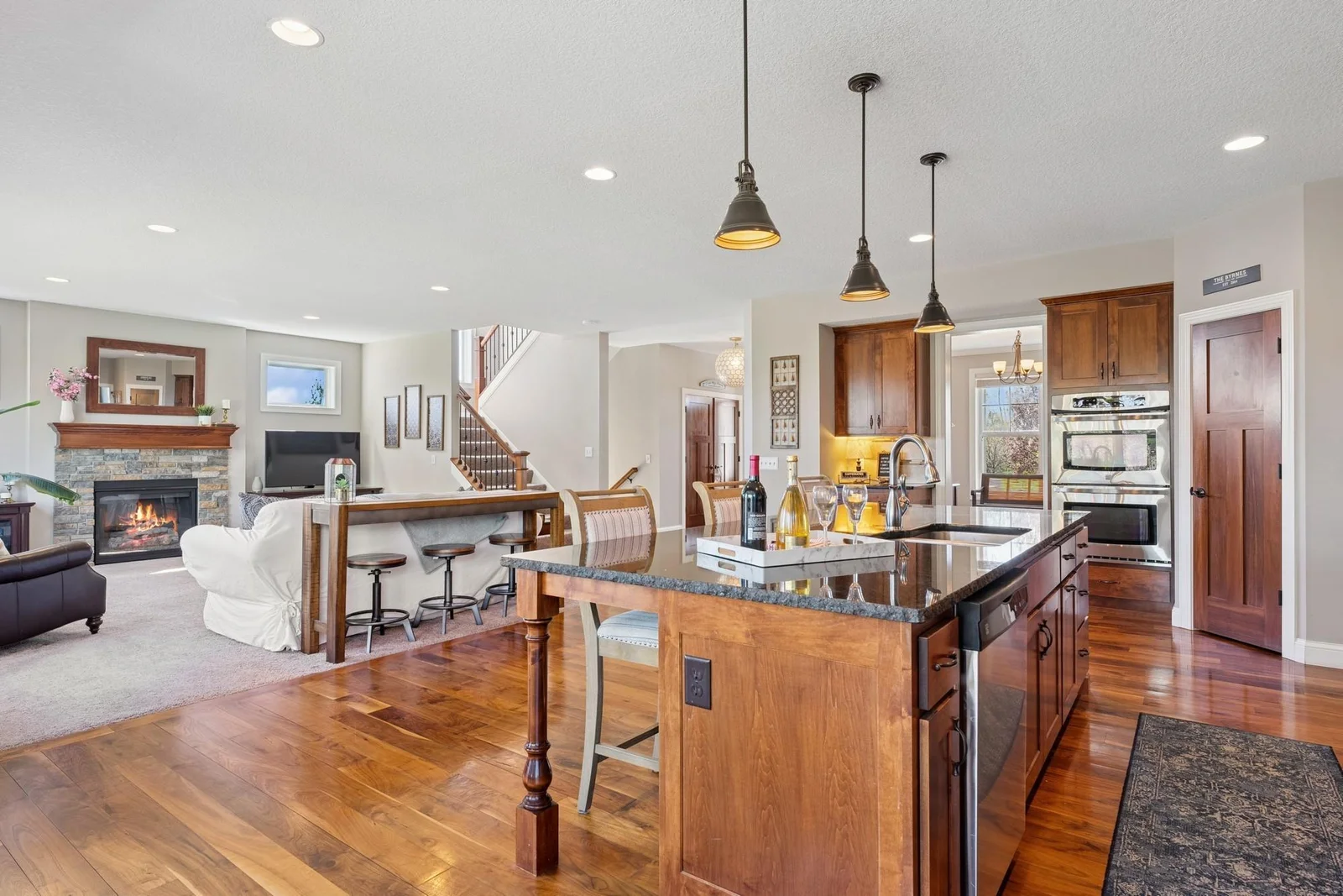 The kitchen features lots of additional cabinetry, a double wall oven/gas cooktop combo, and would you look at all those recessed lights?