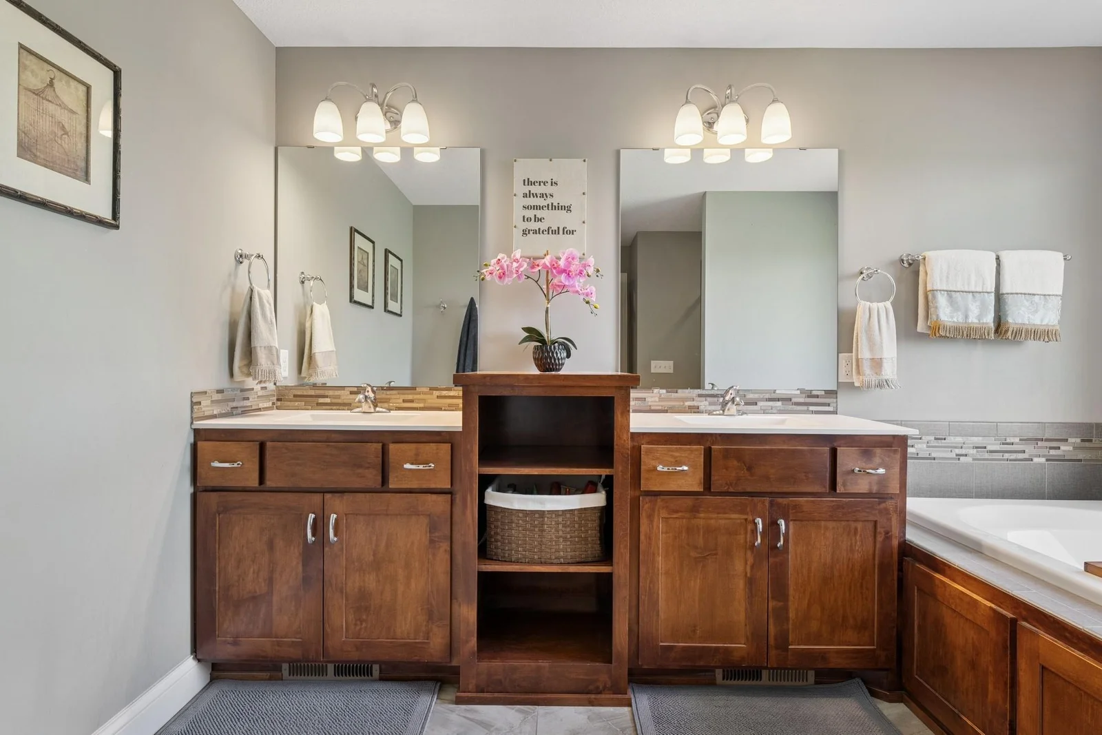 The dual sink vanity in the private primary bath is custom built, separated to reduce or even prevent arguments over whose toothbrush goes on what side.