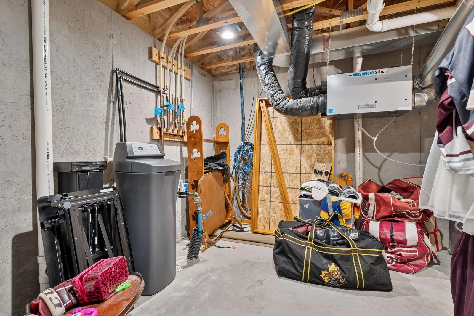 The utility space includes an owned & included water softener, a Venmar Constructo air-exchanger which the builder installed two years before they even became a code requirement, spray-foamed rim joist, and 19" on center floor trusses.