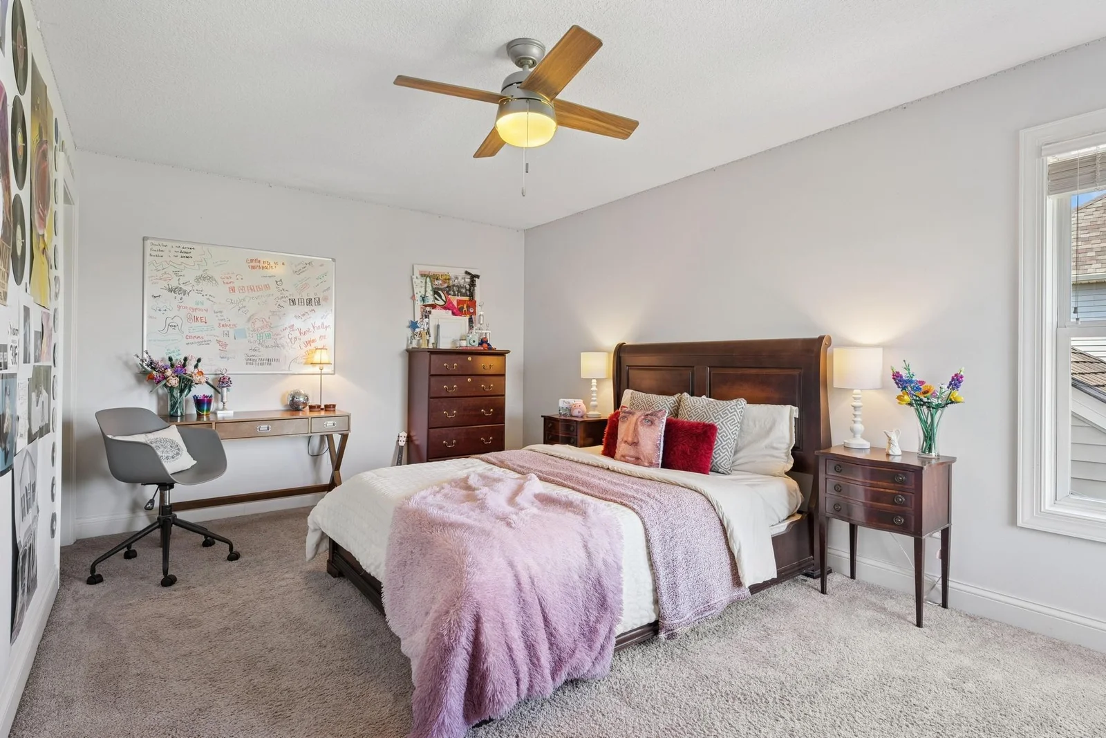 The 4th of 4 upper level bedrooms features a walk-in closet, a ceiling fan and a private bathroom.