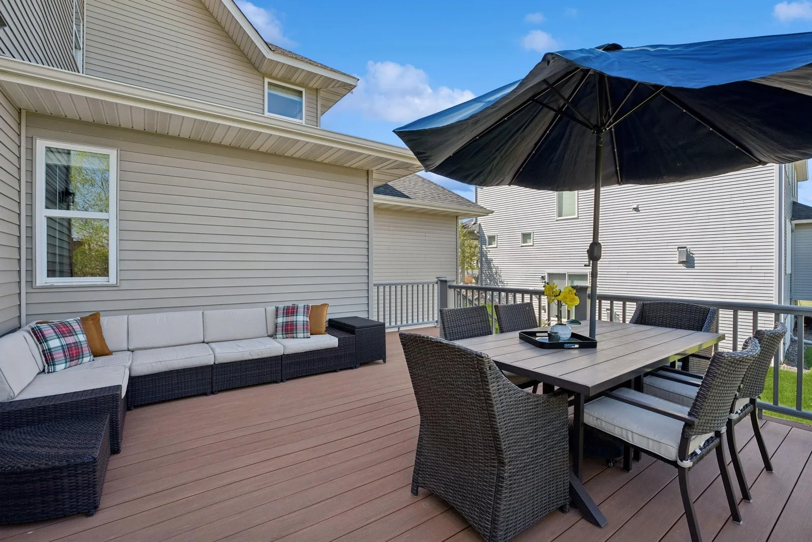 The low-maintenance deck is huge, and has room for this sofa and this dining table!