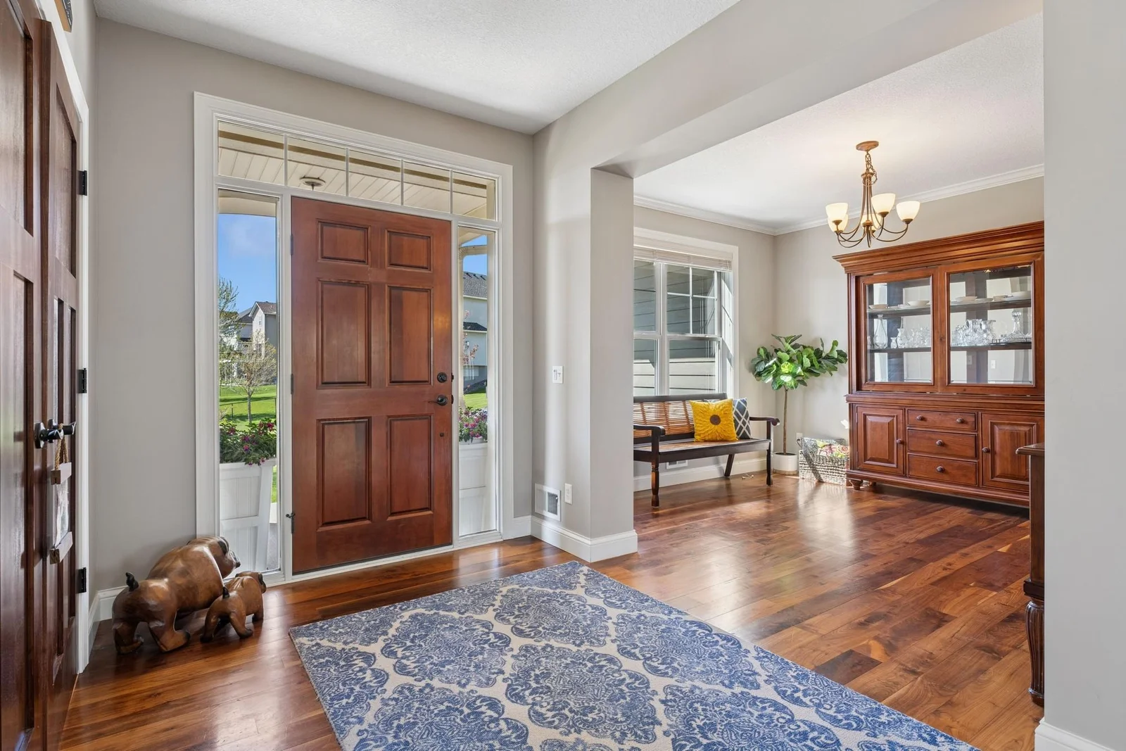 Your extra large foyer is so bright and connects directly to the formal dining room and home office. Don't you love the floors? They're solid walnut. The front door has dual sidelights and a transom window.