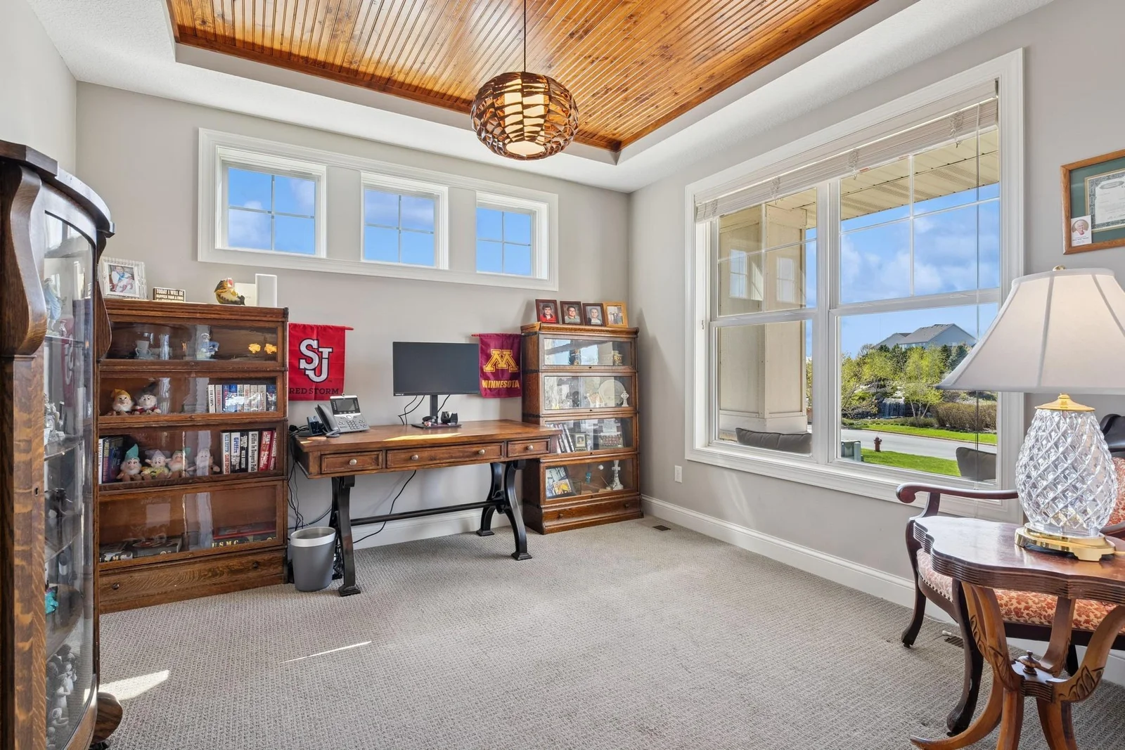 The main level home office is stunning, with upgraded carpet, a character-rich beadboard ceiling, a transom window and XL windows.