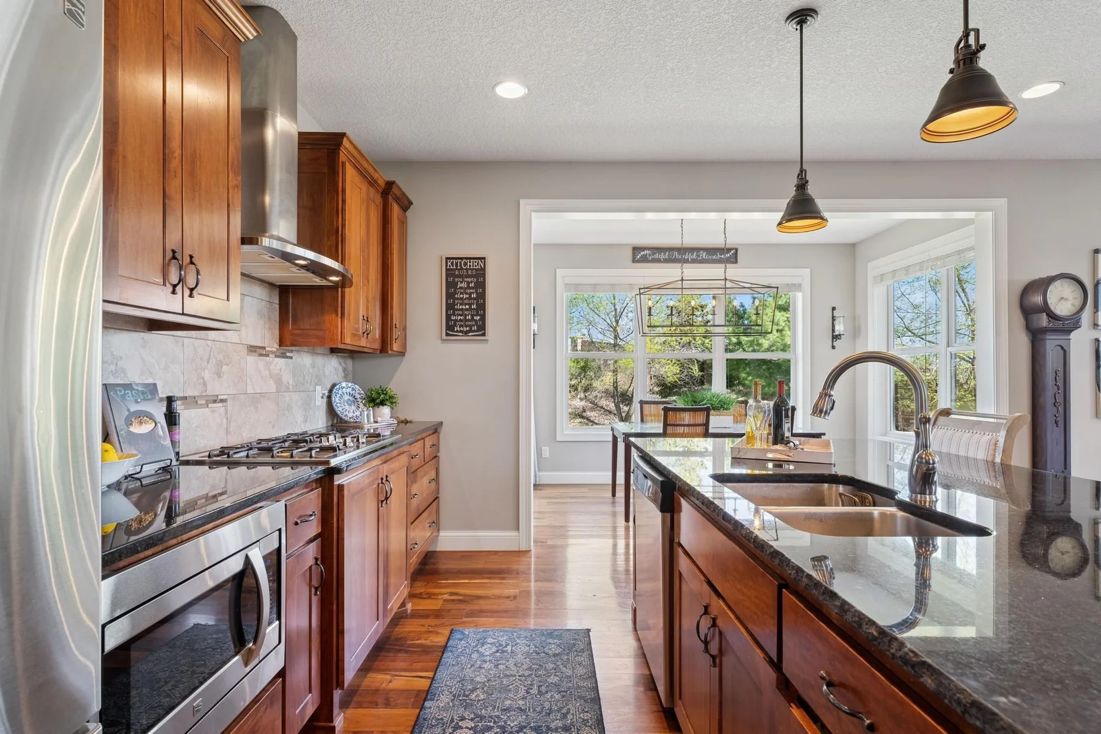 The granite countertops and tile backsplash add even more luxury to this luxurious kitchen. The dual basin stainless sink features a disposal too.