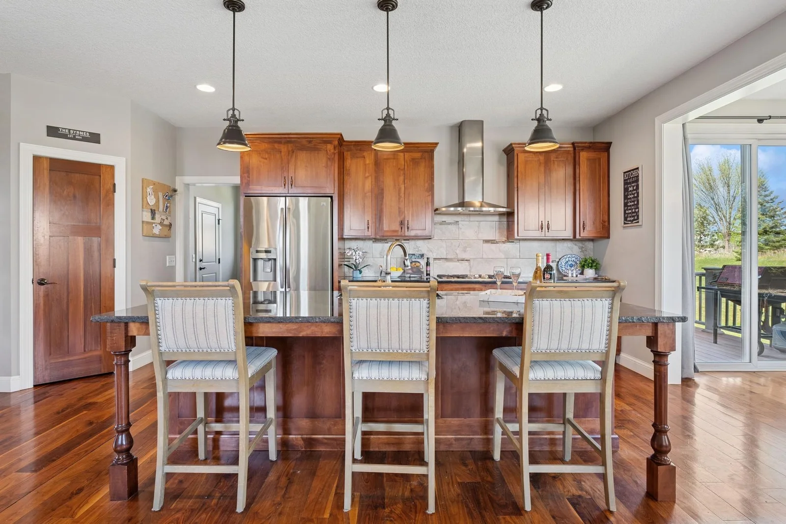 The deluxe, gourmet center island kitchen features an awesome walk-in pantry, direct connection to the formal AND informal dining room, which also connects to the 16 x 16 Trex deck.