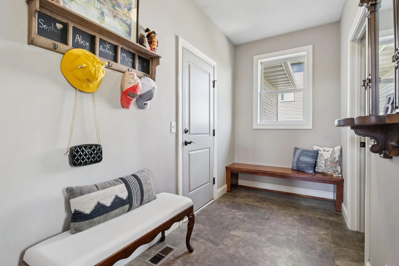 The mud room has low-maintenance & easy-to-clean vinyl flooring, direct garage access, an operable window, a storage closet and a half bath.