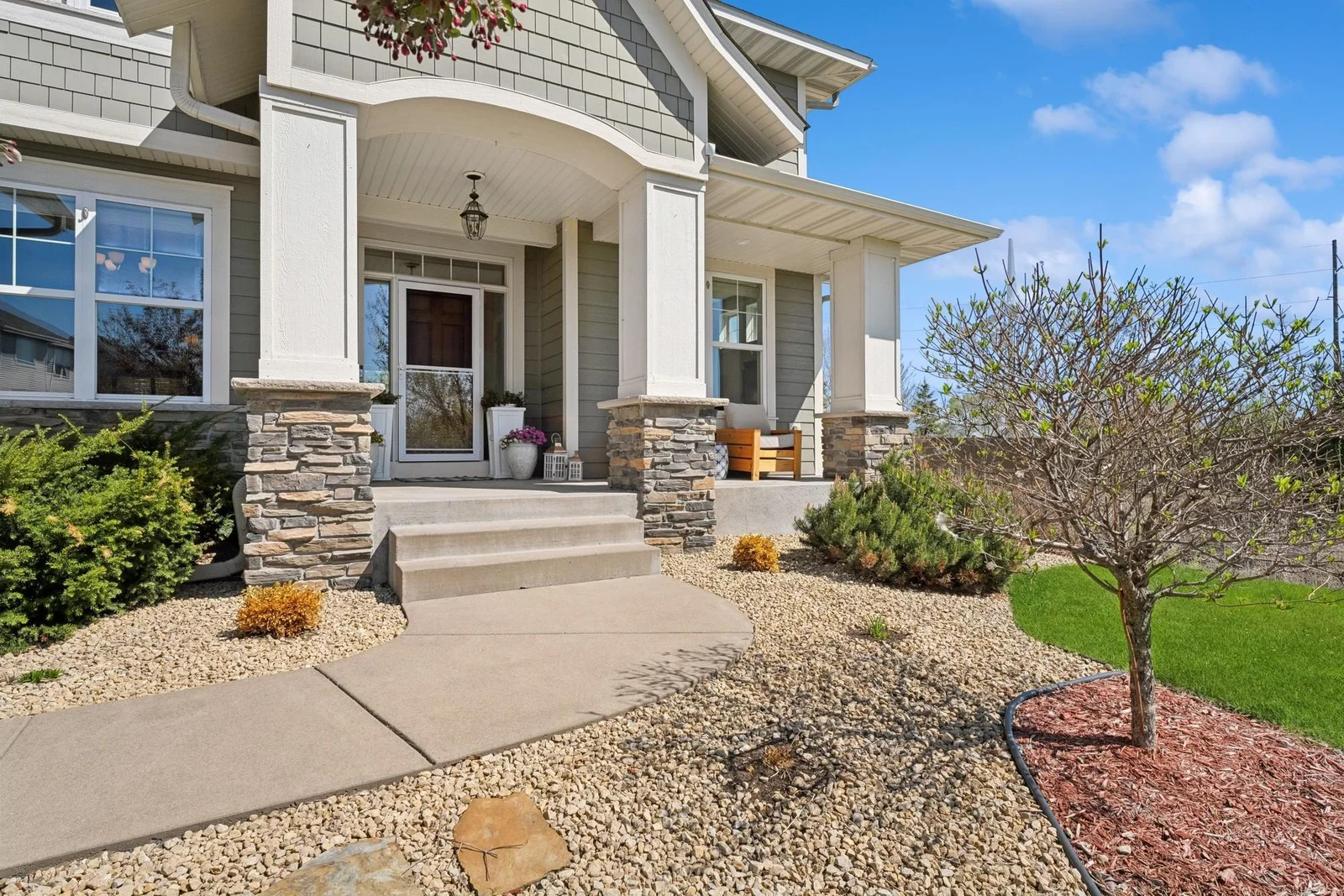 The covered 21 x 5 concrete front porch features a chandelier, a soffit light and a weatherproof electrical outlet. The outside lights are on a timer as well.