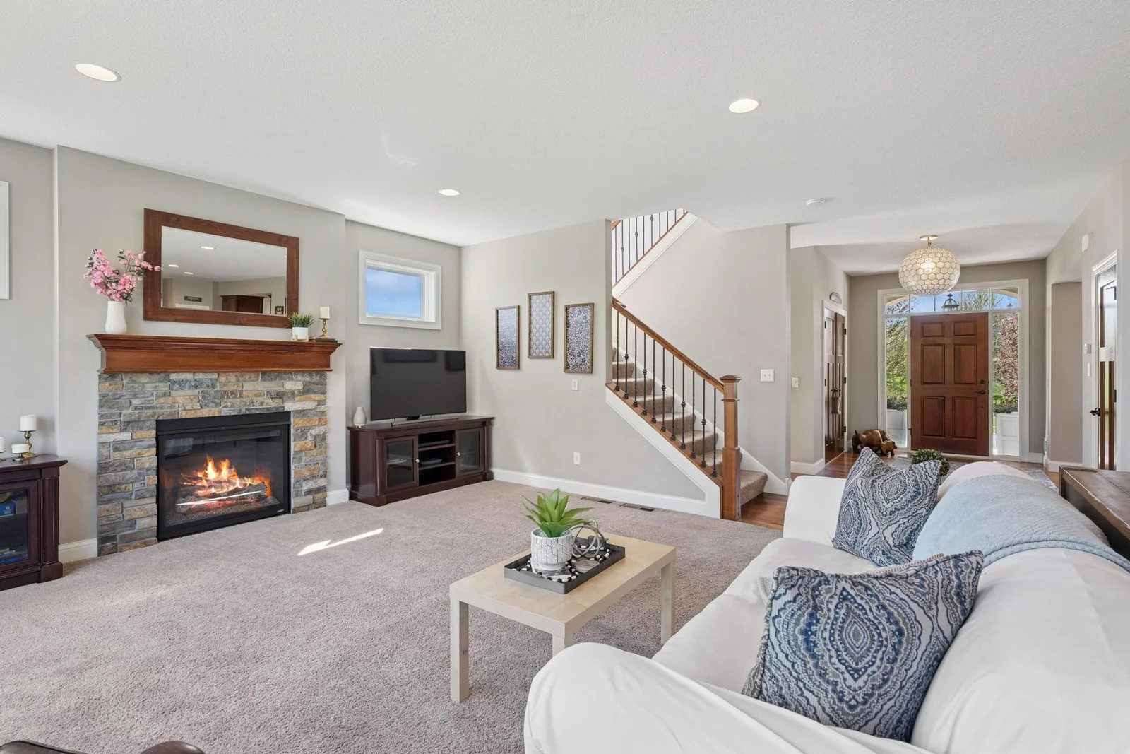 The main level family room features 9' ceilings, recessed lighting, south facing transom windows & a gas fireplace.