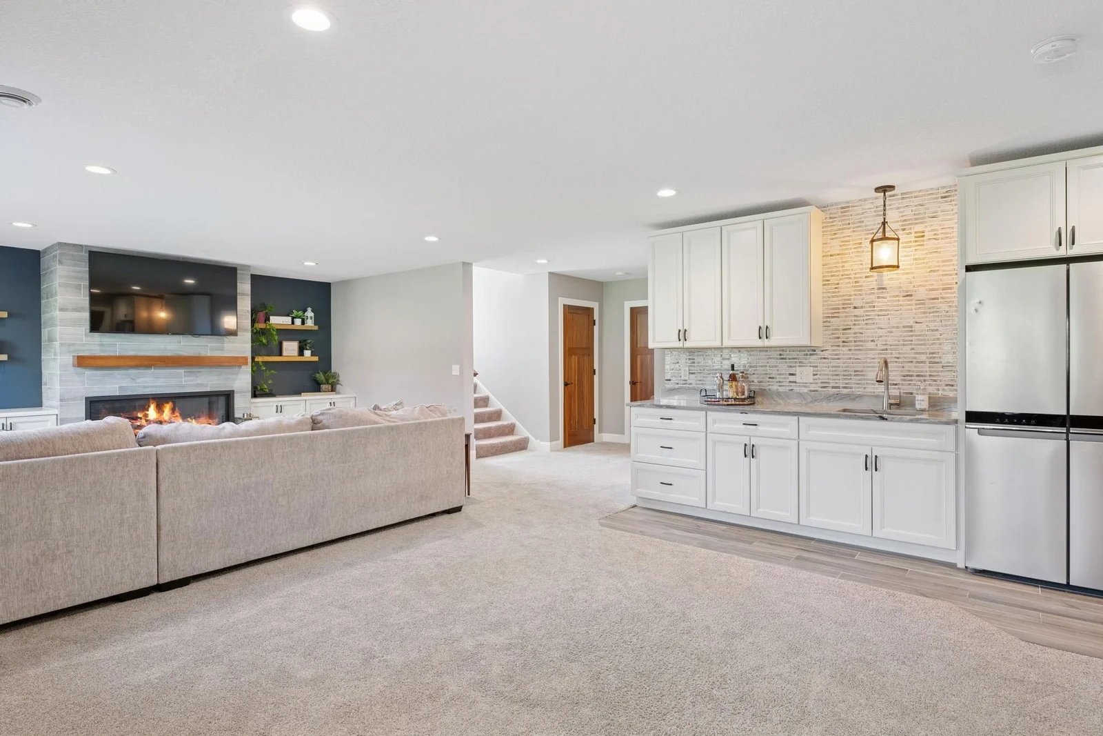 The extra-plush carpet feels so nice underfoot, and the floor smartly transitions to tile around the wet bar.