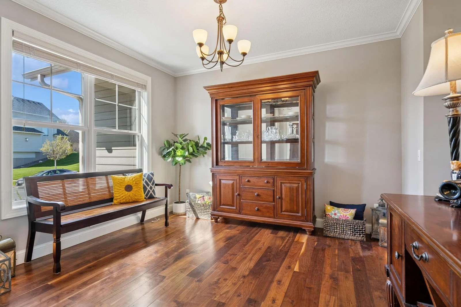 The formal dining room has solid walnut floors, crown molding and large windows, and it connects directly to the kitchen for easy dinner party entertaining.