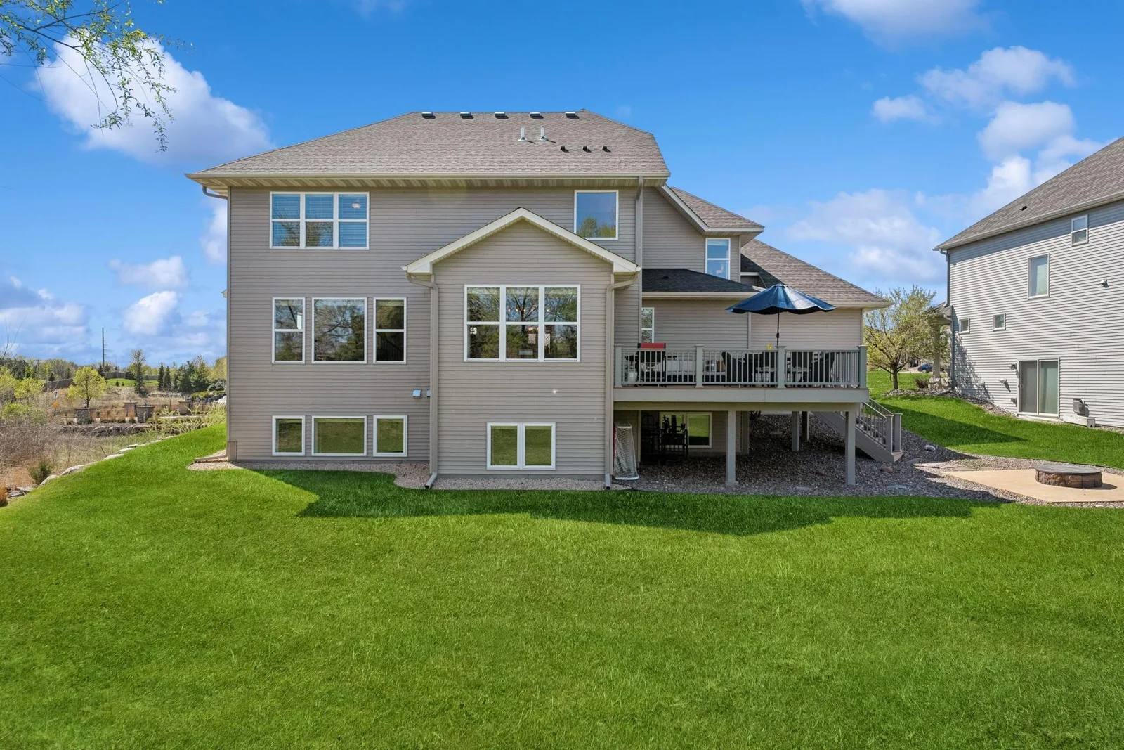 As you can see here, there are gutters & downspouts, a deck AND a patio. Also, the home is fully equipped with window treatments. All these things can't be said about most new homes.