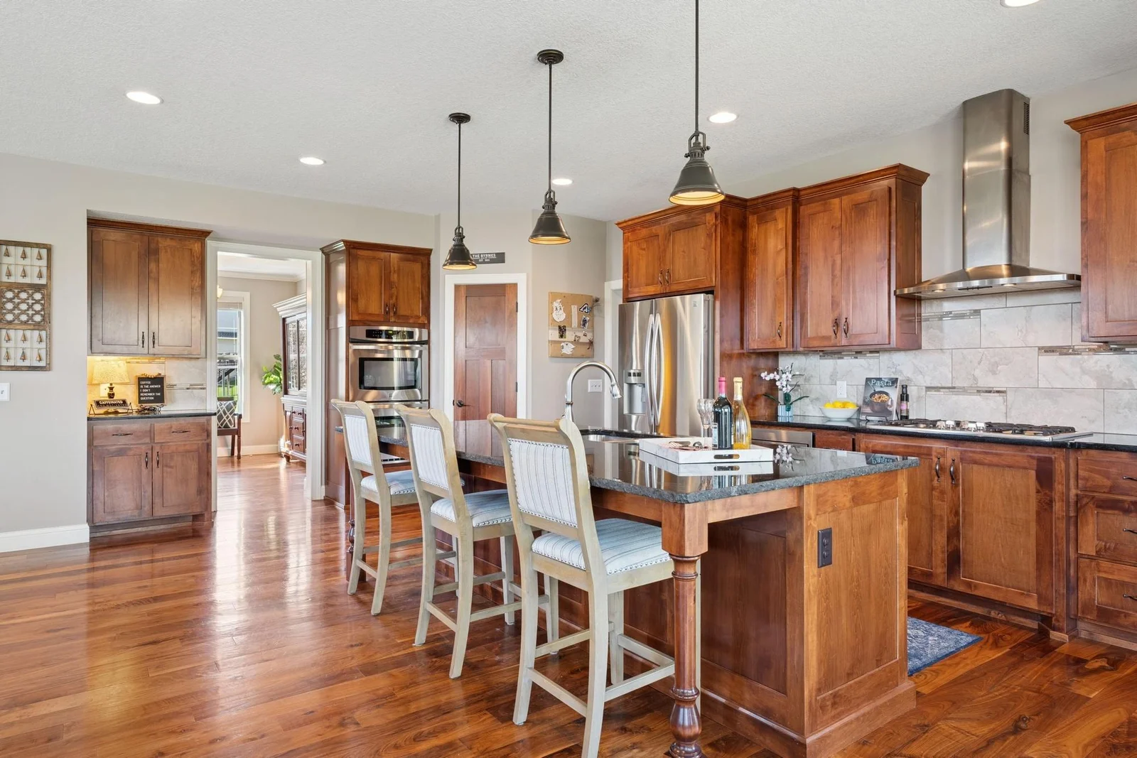 The cabinets feature crown moldings & 42" uppers, extra deep pots & pans spaces, and even an outlet in the island, which new homes can't have, per new building codes.