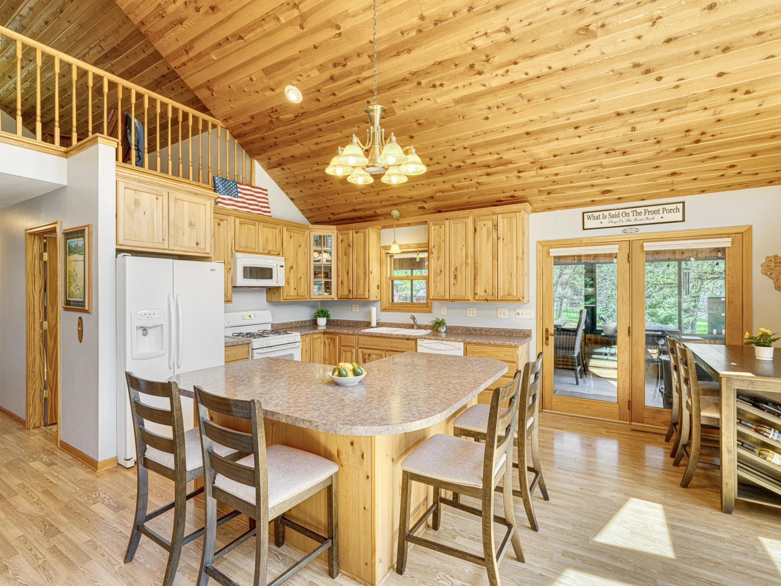 Kitchen features of plenty of storage space and informal countertop seating.