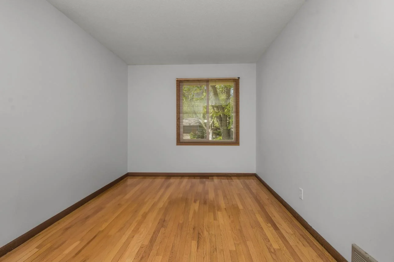 Second of two bedrooms on main level also has hardwood and a well sized window.