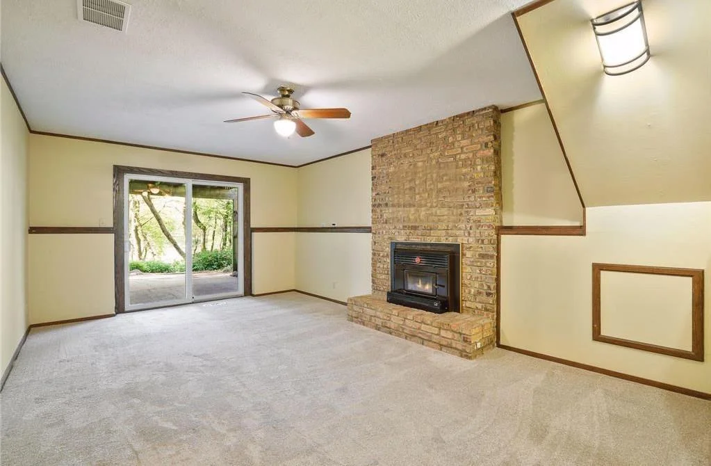 Family room in the lower walkout level with wood burning fireplace and lots of storage.