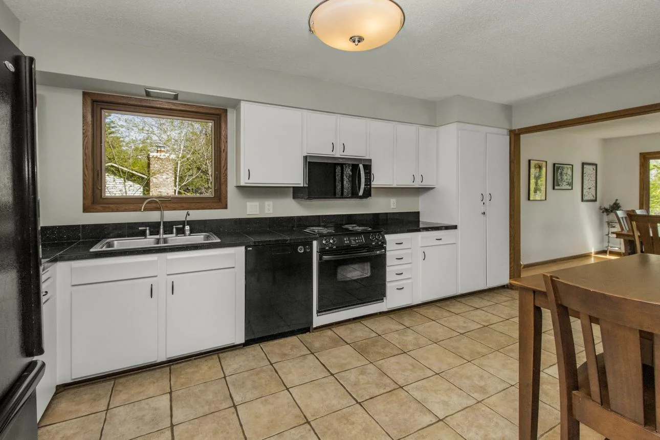 Large kitchen with eat-in option!  Dual sinks, lots of counter space and storage (note the pantry to far right).