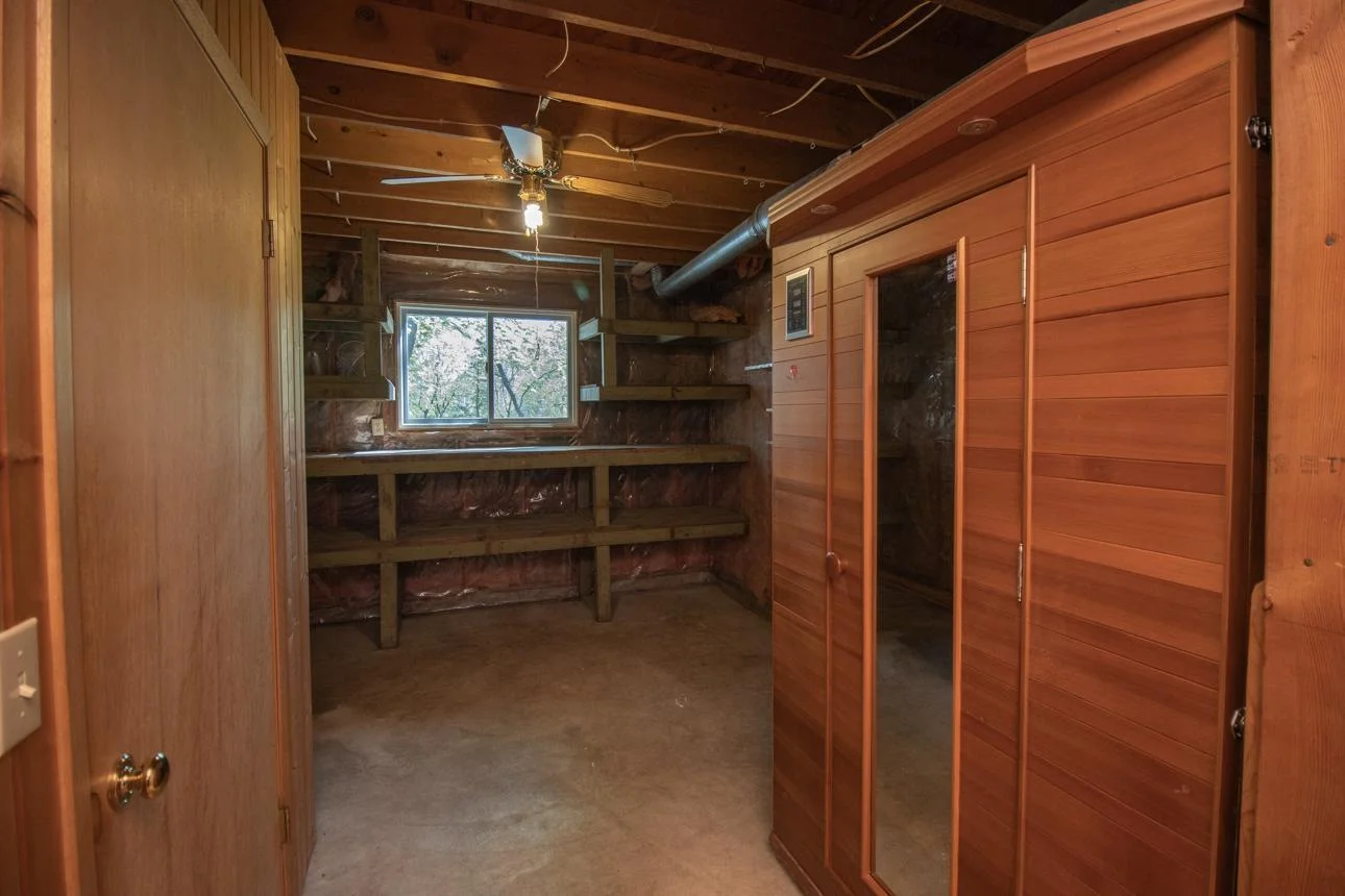 Don't miss the infrared sauna tucked into this unfinished area! Workbench and storage just beyond.