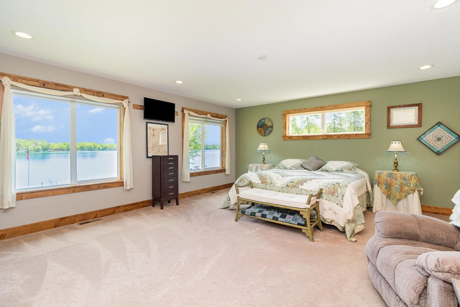 Primary bedroom over looking the lake with attached laundry room and office
