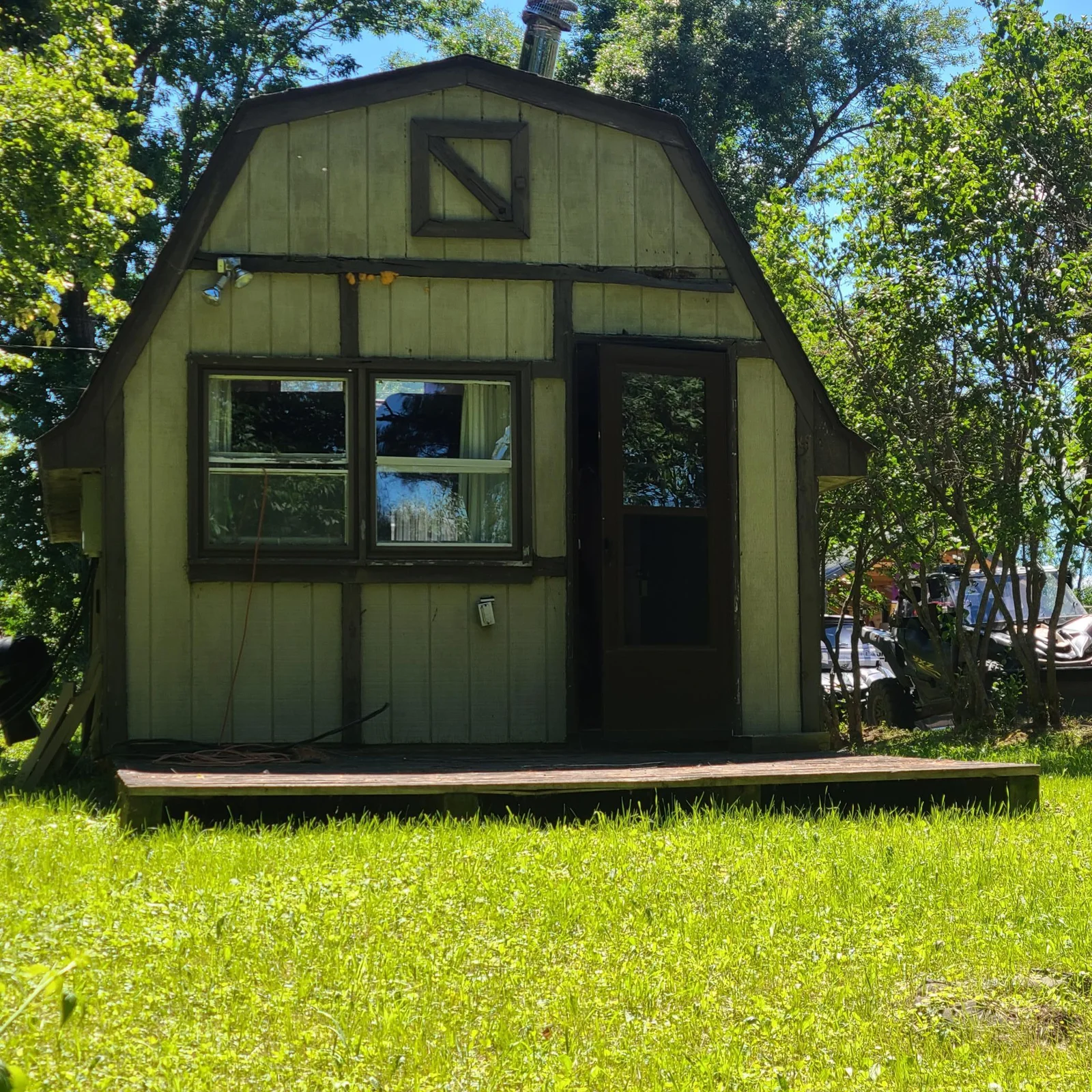Front of Cabin with small wooden patio