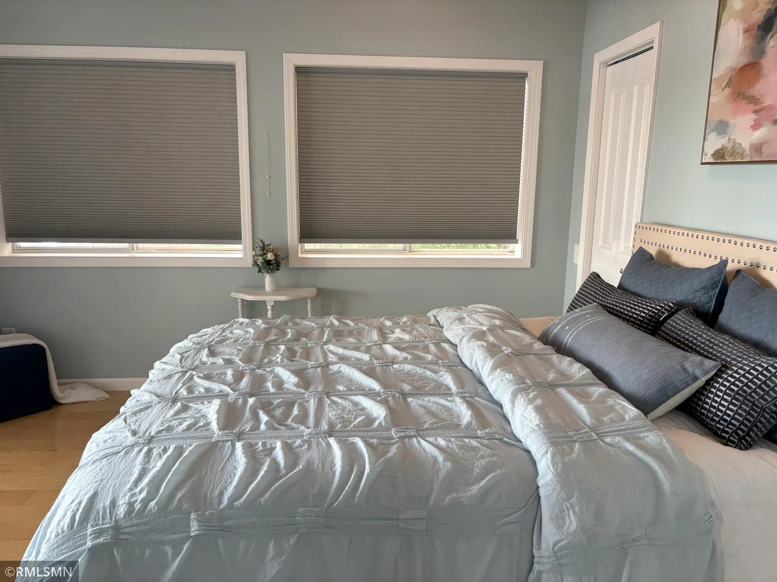 Bedroom equipped with walk-in closet, new window coverings and lakeside patio door