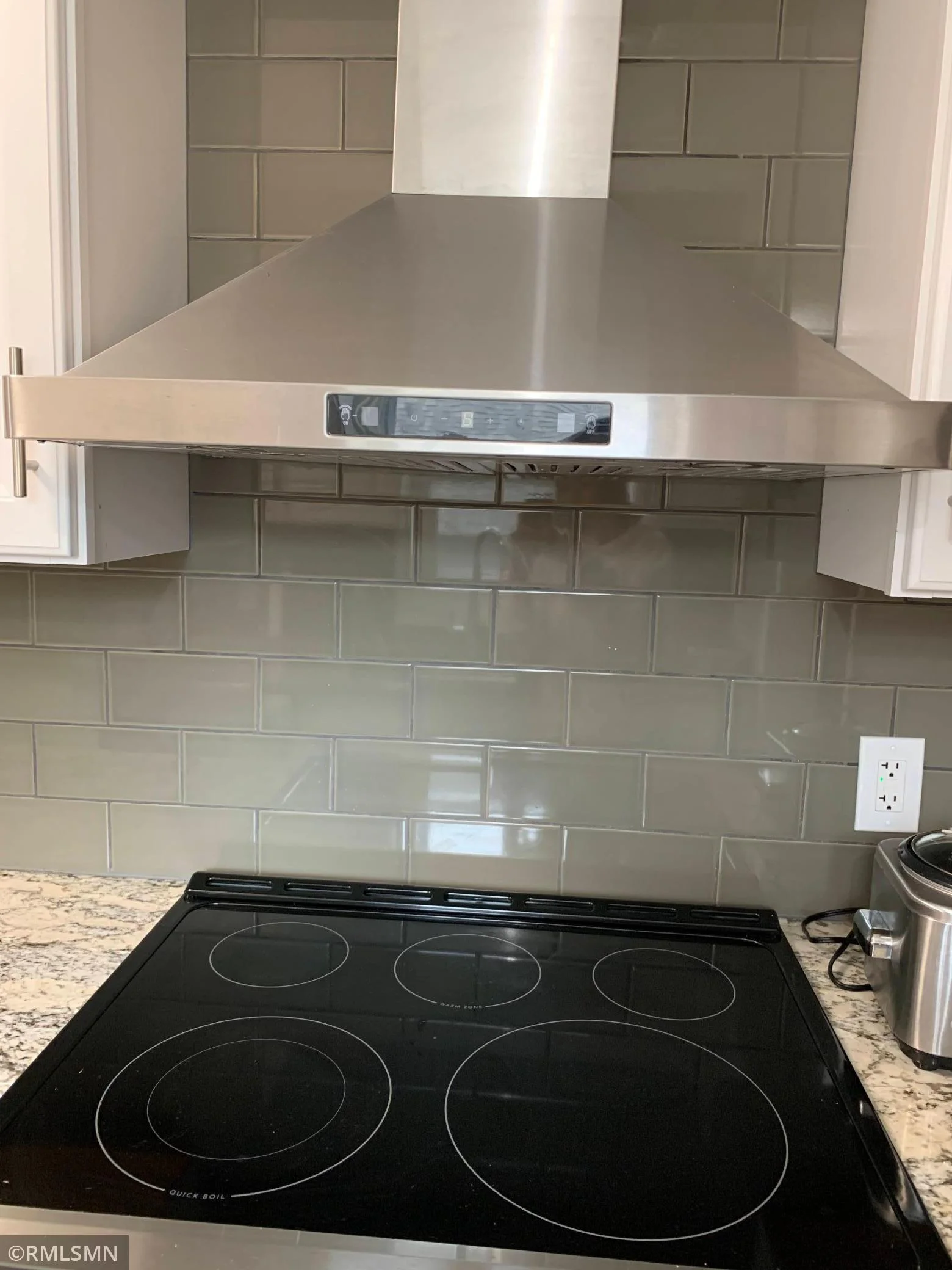 New electric stove, glass tile backsplash and hood fan