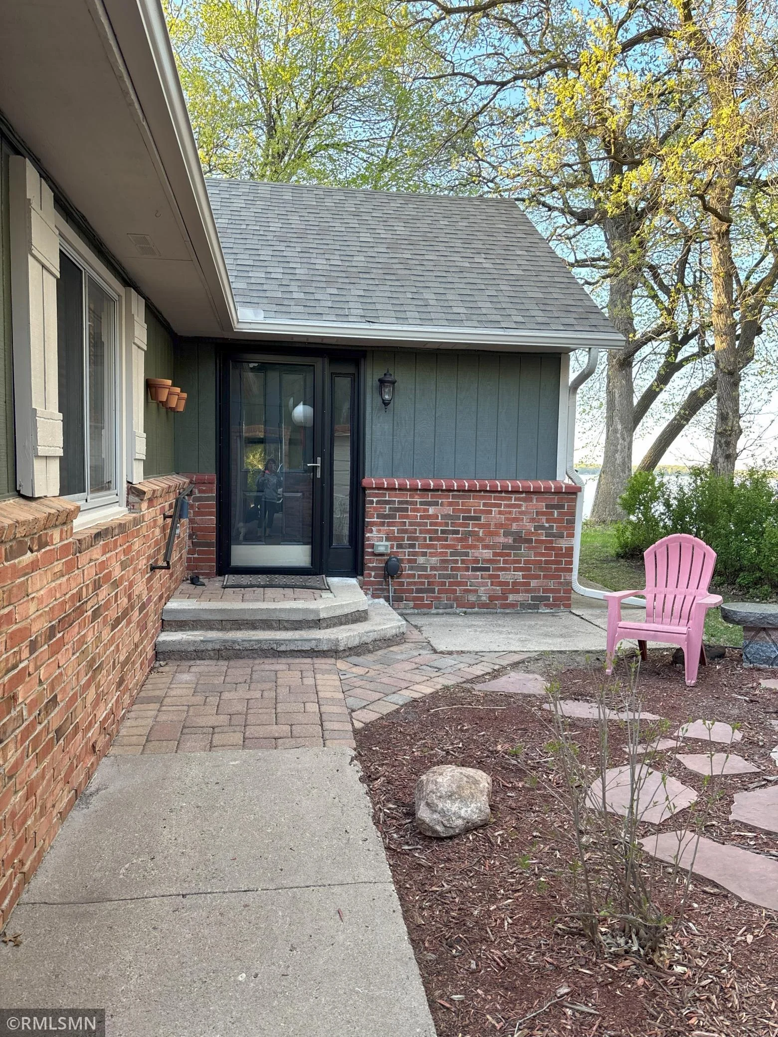 Private entry into the home with new storm door, and new roof.
