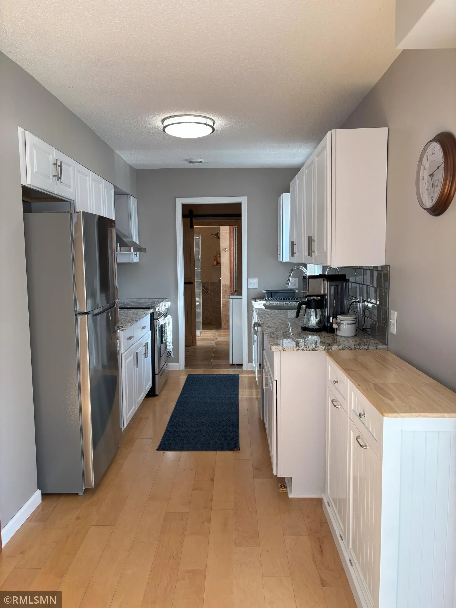 New galley kitchen fully equipped with new stainless steel appliances