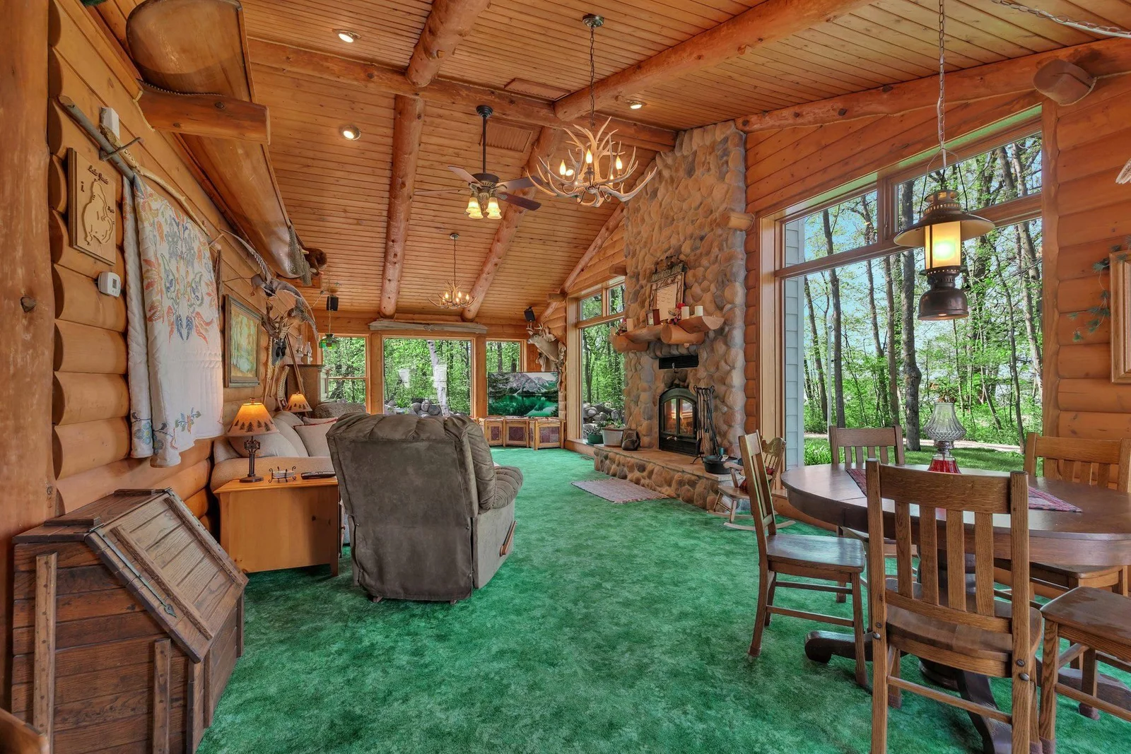 Log-sided & beamed ceilings in the Great Room. Stone mantel fireplace. Antler Chandelier. You've just been transported 'Up North'!