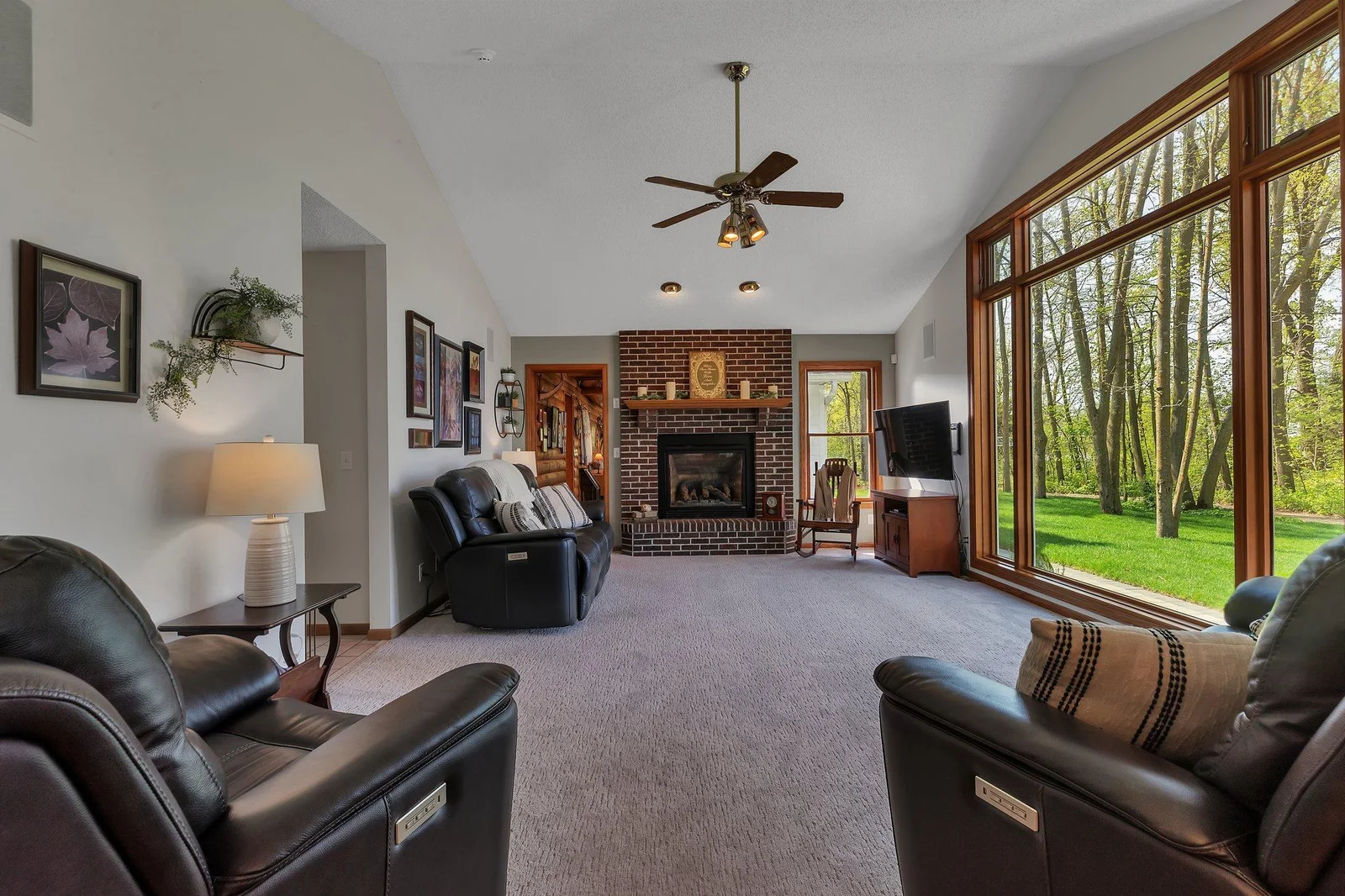 Main floor living room. Gas-burning fireplace is furnace-rated. New floor-to-ceiling windows.