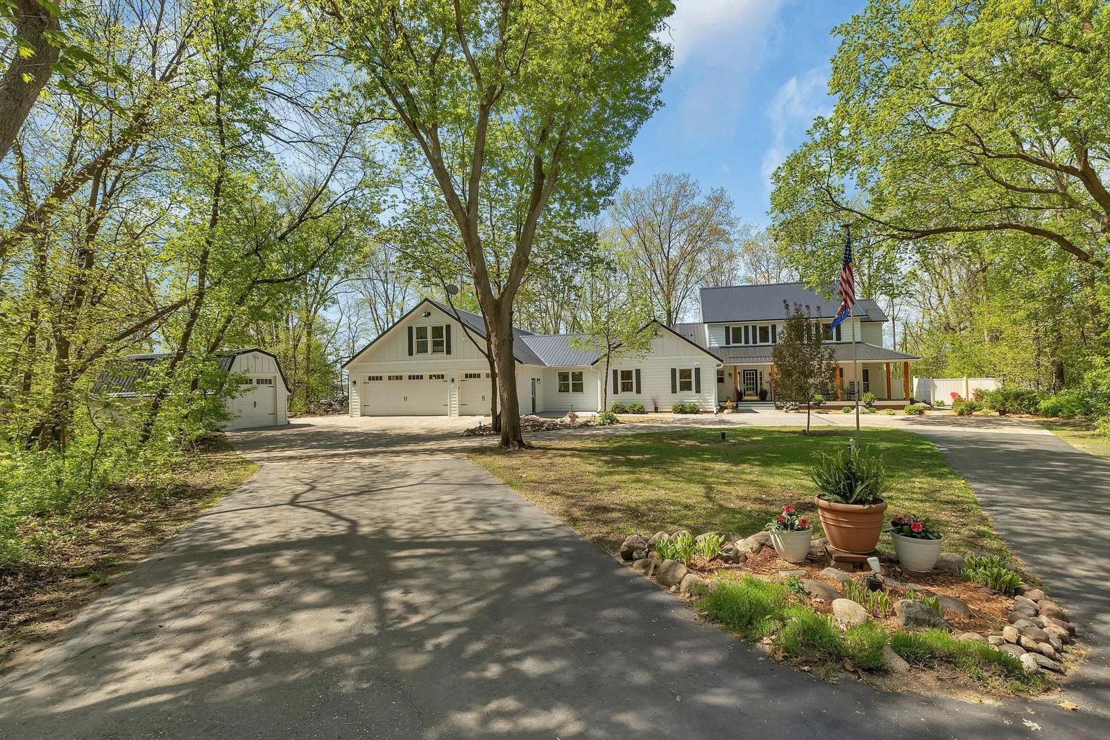 Modern Farmhouse Ensconced in Wooded Lot.