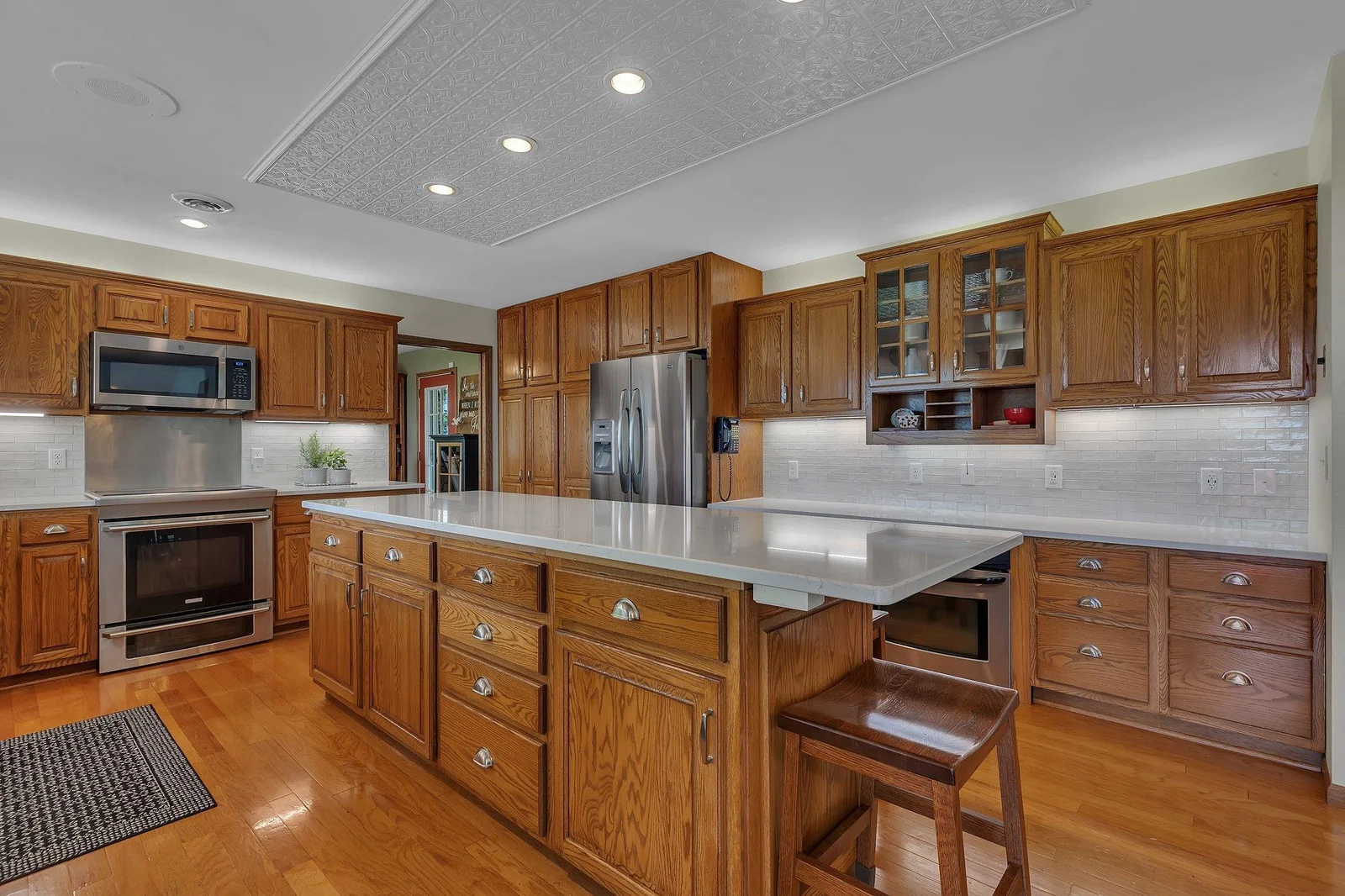 Plentiful cupboards and workspaces maximize the practicality and functionality of this incredible kitchen!
