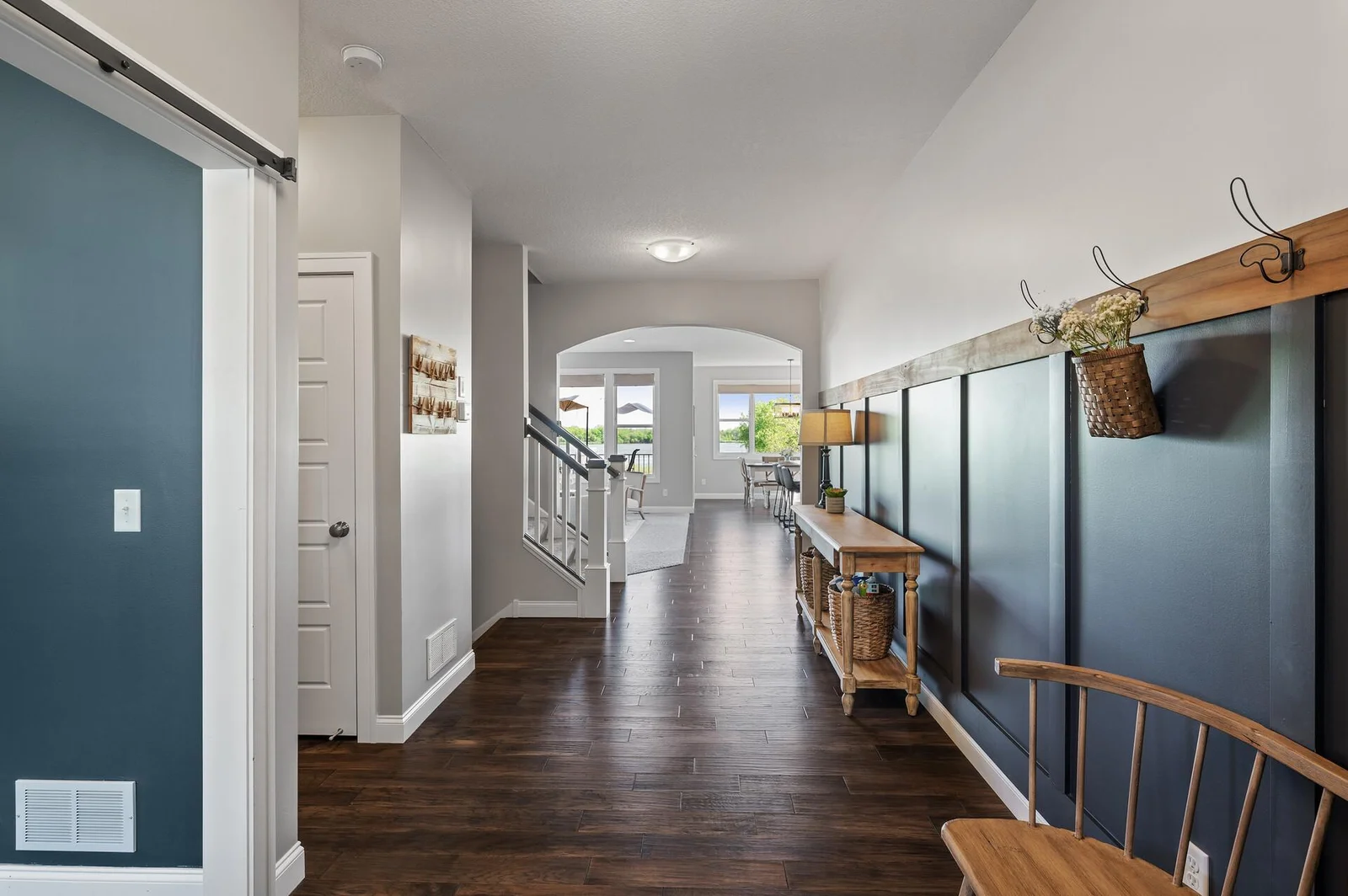 Dark, rich hardwood floors flow from the entry, to the office, and into the kitchen and eating space.