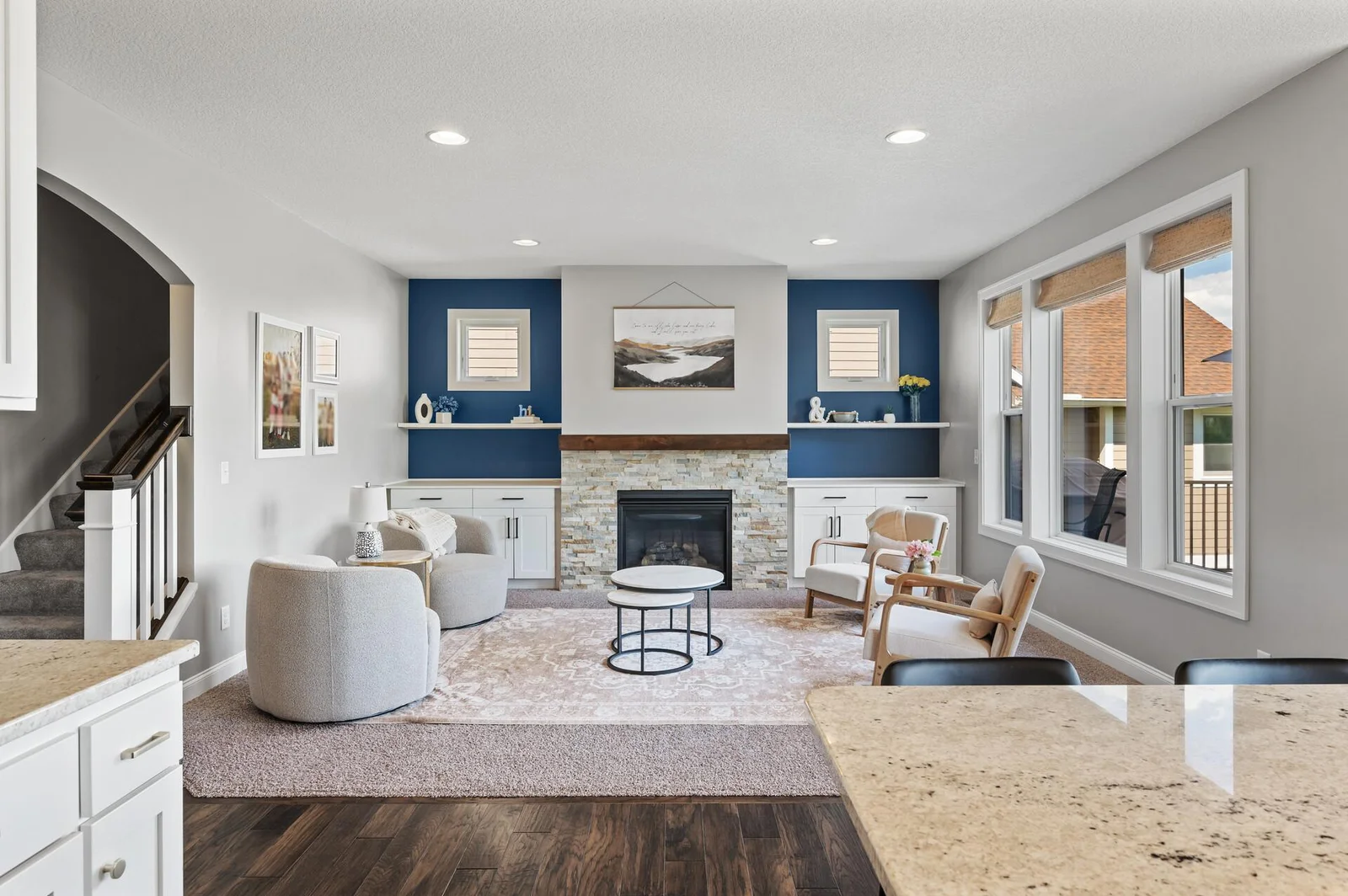 Built-in storage on either side of the gas fireplace. Accented with a splash of deep navy.